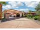 Attractive home featuring a portico, circular driveway, and lush landscaping at 9111 W Stephen Ave, Las Vegas, NV 89149