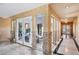 Hallway featuring marble floors, stone accents, and views to an outdoor atrium at 9111 W Stephen Ave, Las Vegas, NV 89149