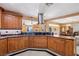 Spacious kitchen featuring wood cabinets, granite countertops, and stainless steel hood at 9111 W Stephen Ave, Las Vegas, NV 89149