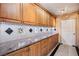 Kitchen featuring granite counters, ample cabinet space, and a sleek backsplash at 9111 W Stephen Ave, Las Vegas, NV 89149