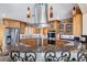 Stylish kitchen featuring granite counters, stainless appliances, and wood cabinets at 9111 W Stephen Ave, Las Vegas, NV 89149