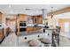 Open kitchen with granite countertops, custom cabinetry, and a stylish breakfast bar at 9111 W Stephen Ave, Las Vegas, NV 89149