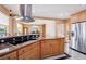Modern kitchen showcasing granite countertops, stainless steel appliances, and a stylish hood at 9111 W Stephen Ave, Las Vegas, NV 89149