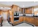 Well-equipped kitchen with stainless steel appliances, granite countertops, and wood cabinetry at 9111 W Stephen Ave, Las Vegas, NV 89149