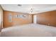 Bright and open living room featuring carpet, ceiling fan, and natural light at 9111 W Stephen Ave, Las Vegas, NV 89149