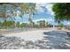 Expansive outdoor space featuring a tennis court and scenic palm trees under a clear, blue sky at 9111 W Stephen Ave, Las Vegas, NV 89149