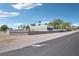 Fenced, empty lot with a metal structure on a sunny day at 9111 W Stephen Ave, Las Vegas, NV 89149