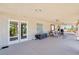 Covered patio featuring sliding glass doors and an outdoor seating area, perfect for entertaining at 9111 W Stephen Ave, Las Vegas, NV 89149