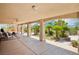 Inviting covered patio offers ample seating and overlooks a lush tropical garden oasis at 9111 W Stephen Ave, Las Vegas, NV 89149