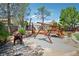 This backyard features a wooden swing set and unique metal animal sculptures, creating a whimsical play area at 9111 W Stephen Ave, Las Vegas, NV 89149