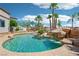 Stunning backyard pool features waterfalls, lush palm trees, and a tanning ledge at 9111 W Stephen Ave, Las Vegas, NV 89149