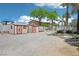 Backyard featuring storage sheds, secure gated access, and ample gravel space, offering practicality and security at 9111 W Stephen Ave, Las Vegas, NV 89149