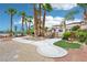 Scenic walkway leading to a charming outdoor area with palm trees, lush greenery, and a cozy seating area at 9111 W Stephen Ave, Las Vegas, NV 89149
