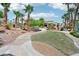 Lush landscaping and curved walkway leads to the home, enhanced by mature trees and desert plants at 9111 W Stephen Ave, Las Vegas, NV 89149