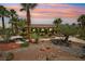 Beautifully landscaped front yard with stone, cacti, and palm trees enhancing the property's appeal at 9111 W Stephen Ave, Las Vegas, NV 89149