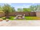 Landscaped backyard featuring pavers, grass, and seating at 9161 Rolling Sky Dr, Las Vegas, NV 89178