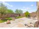 Landscaped backyard featuring pavers, grass, and seating at 9161 Rolling Sky Dr, Las Vegas, NV 89178