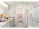 Modern bathroom featuring double sinks, granite countertops, and a glass enclosed shower at 9161 Rolling Sky Dr, Las Vegas, NV 89178