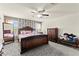 Spacious primary bedroom showcasing carpet floors, a ceiling fan, and natural light from windows at 9161 Rolling Sky Dr, Las Vegas, NV 89178