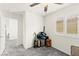 Bright, carpeted bedroom with plantation shutters and ceiling fan at 9161 Rolling Sky Dr, Las Vegas, NV 89178