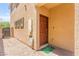 Inviting front entry with covered porch and desert landscaping at 9161 Rolling Sky Dr, Las Vegas, NV 89178