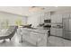 Bright kitchen featuring granite countertops, stainless steel appliances, and modern lighting at 9161 Rolling Sky Dr, Las Vegas, NV 89178