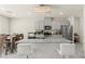 Modern kitchen features gray cabinets, stainless appliances, and a granite countertop island with seating at 9161 Rolling Sky Dr, Las Vegas, NV 89178