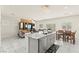 Open-concept kitchen and living room with granite counters, stainless appliances, and tile floors at 9161 Rolling Sky Dr, Las Vegas, NV 89178