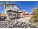 Back exterior of house with patio, landscaping, and backyard view with privacy wall at 9321 Dancing Daffodil Ave, Las Vegas, NV 89129