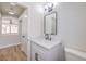 Stylish powder bath with a white vanity, matte black faucet, and a modern framed mirror at 9321 Dancing Daffodil Ave, Las Vegas, NV 89129