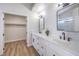 Bathroom featuring dual vanities, quartz countertops, and modern black hardware at 9321 Dancing Daffodil Ave, Las Vegas, NV 89129