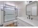 Updated bathroom with vanity, quartz countertop, new faucet, and tiled shower at 9321 Dancing Daffodil Ave, Las Vegas, NV 89129