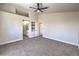Spacious bedroom with a ceiling fan, neutral carpet, and an ensuite bathroom at 9321 Dancing Daffodil Ave, Las Vegas, NV 89129