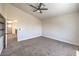 Bedroom features a modern ceiling fan, plush carpeting, and a closet, with an open door at 9321 Dancing Daffodil Ave, Las Vegas, NV 89129