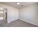 Carpeted bedroom featuring sliding door closet and a doorway view of the upstairs landing at 9321 Dancing Daffodil Ave, Las Vegas, NV 89129