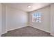 Bedroom with neutral carpet and a window overlooking the neighborhood at 9321 Dancing Daffodil Ave, Las Vegas, NV 89129