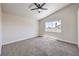 Vaulted bedroom with neutral carpet, a modern ceiling fan, and a window with neighborhood views at 9321 Dancing Daffodil Ave, Las Vegas, NV 89129