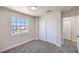 Bedroom with neutral carpet, a window overlooking the neighborhood, and a closet at 9321 Dancing Daffodil Ave, Las Vegas, NV 89129