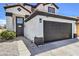 Two story home featuring a tile roof, dark trim, and desert landscaping at 9321 Dancing Daffodil Ave, Las Vegas, NV 89129