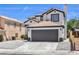 Two story home featuring a tile roof, dark trim, and desert landscaping at 9321 Dancing Daffodil Ave, Las Vegas, NV 89129