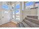 Light and airy foyer with staircase and large windows at 9321 Dancing Daffodil Ave, Las Vegas, NV 89129