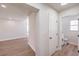 Hallway leads to a powder room with a white vanity and views of the open-concept first floor at 9321 Dancing Daffodil Ave, Las Vegas, NV 89129