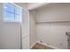 Bright laundry room featuring hookups, shelving, a window, and white wood-look vinyl floors at 9321 Dancing Daffodil Ave, Las Vegas, NV 89129