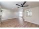Spacious living room featuring wood-look flooring, a modern ceiling fan, and lots of natural light at 9321 Dancing Daffodil Ave, Las Vegas, NV 89129
