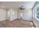 Inviting living room with wood-style floors, neutral walls, and a view into other rooms at 9321 Dancing Daffodil Ave, Las Vegas, NV 89129