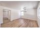 Open-concept living space featuring modern chandelier and wood-look flooring at 9321 Dancing Daffodil Ave, Las Vegas, NV 89129