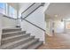 Carpeted staircase features black iron railings and leads to the upper level of the home at 9321 Dancing Daffodil Ave, Las Vegas, NV 89129