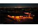 Panoramic aerial shot of the house at dusk with outdoor lights illuminating the walkway and front entrance at 9865 Bright Angel Way, Las Vegas, NV 89149