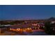 Scenic aerial view showcasing the home, desert landscape, and city lights in the distance at 9865 Bright Angel Way, Las Vegas, NV 89149