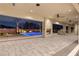 Captivating outdoor living space with a stunning pool, fireplace, and ceiling fans at 9865 Bright Angel Way, Las Vegas, NV 89149